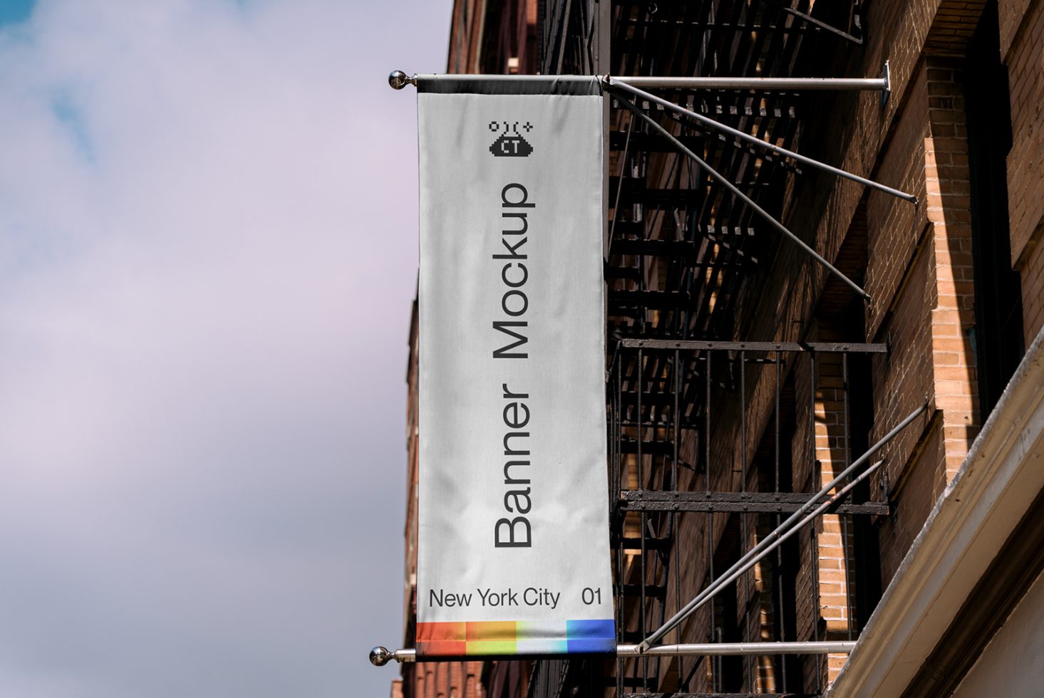 Outdoor vertical banner mockup hanging on a building facade with fire escape, clear sky background, urban design presentation.